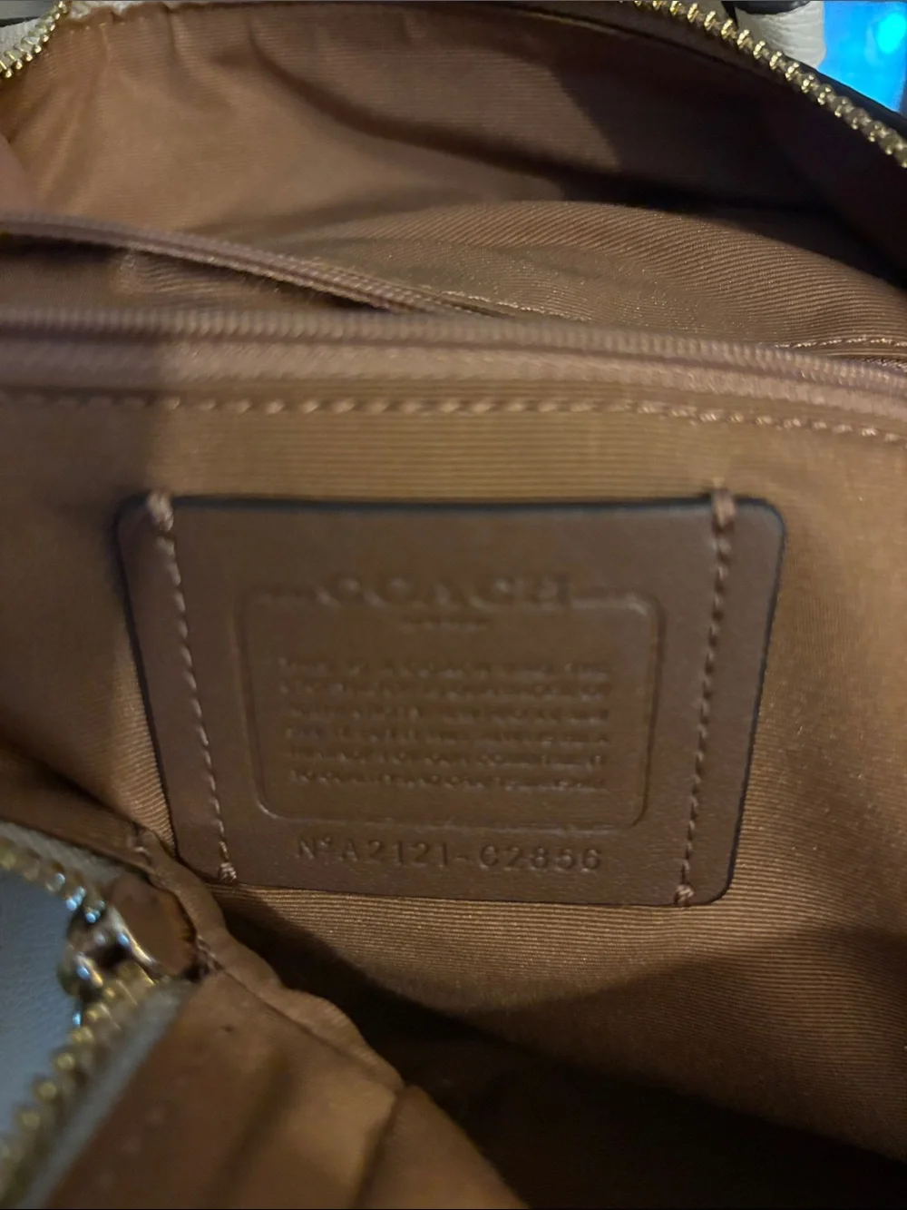 Coach Beige Signature Daisy Backpack with matching wallet.